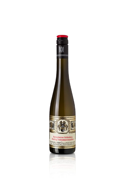 A half-bottle of Riesling TBA Precision Trockenbeerenauslese displaying its radiant, honey-amber liquid hue and clean cream label, resting elegantly next to a premium linen-lined presentation capsule.
