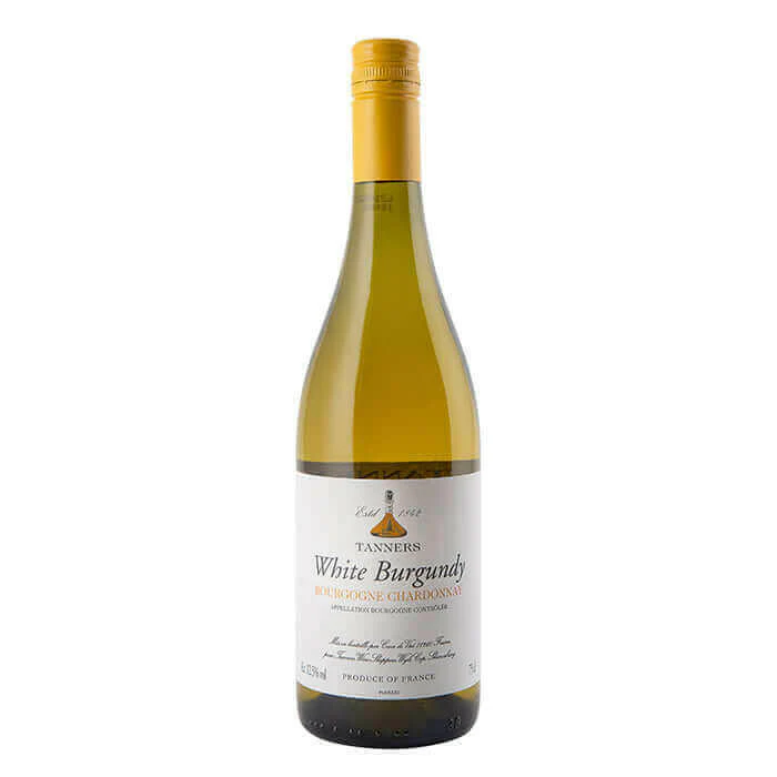 A sleek, traditional heavy-glass bottle of Burgundy Blanc Prestige Grand Cru Chardonnay, displaying its radiant pale gold liquid hue and a minimalist cream-and-gold label inside a luxury cellar.