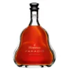 Hennessy Paradis bottle design showcasing its elegant sculptural crystal decanter with sweeping curved lines reflecting liquid gold light while nestled inside its luxury satin lined presentation chest.